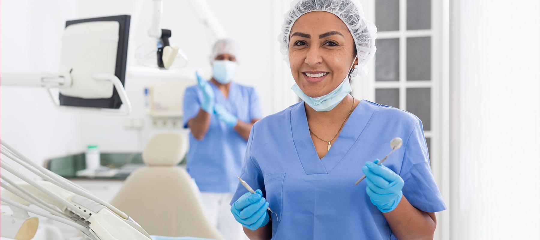 female dental hygienist in blue